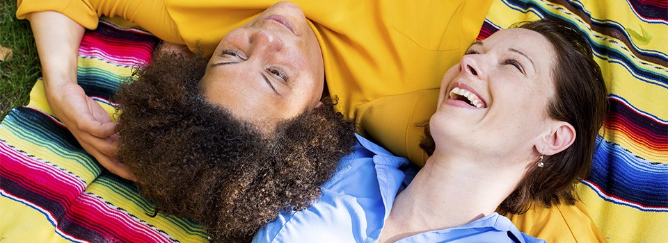 Two Woman Lying On Blanket